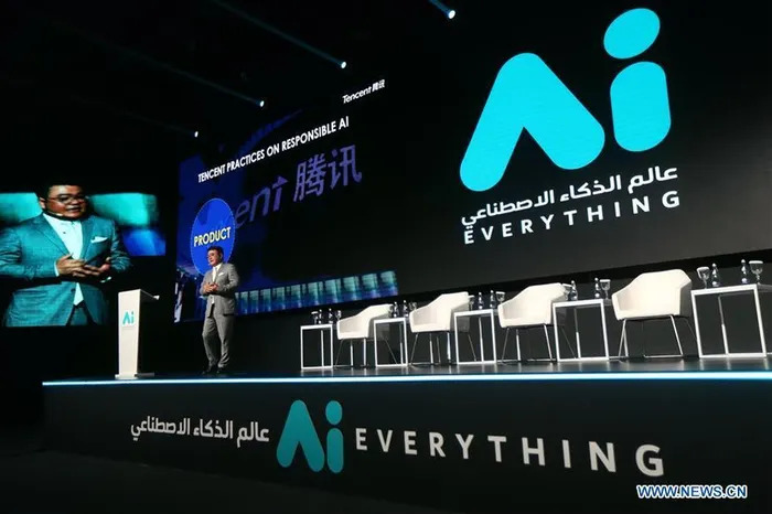 Wide shot of the main stage at the "Ai EVERYTHING" summit with branding and a speaker, a central hub for discussing ai investment middle east.